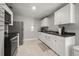 Traditional kitchen features stainless steel appliances, tile floors, and white cabinets at 600 Plum Ln, Altamonte Springs, FL 32701