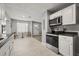 The kitchen features updated stainless steel appliances and access to the dining area at 600 Plum Ln, Altamonte Springs, FL 32701