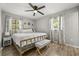This main bedroom has a large bed, ceiling fan, and windows for lots of natural light at 600 Plum Ln, Altamonte Springs, FL 32701