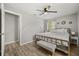 A neutral main bedroom featuring wood floors, a ceiling fan, and a bench at 600 Plum Ln, Altamonte Springs, FL 32701