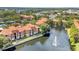 This aerial view shows lush trees, community ponds, and manicured landscaping throughout at 6149 Metrowest Blvd # 103, Orlando, FL 32835