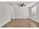 Bright bedroom with light wood floors, a ceiling fan, and ample natural light from a window at 6149 Metrowest Blvd # 103, Orlando, FL 32835