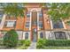 Stylish building exterior with stone accents, lush landscaping, and convenient walkway at 6149 Metrowest Blvd # 103, Orlando, FL 32835