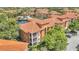 Beautiful waterfront condo featuring screened balconies and a classic tile roof at 6149 Metrowest Blvd # 103, Orlando, FL 32835
