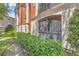Exterior shot of building featuring lush greenery and manicured bushes in front of the building at 6149 Metrowest Blvd # 103, Orlando, FL 32835