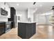 Beautiful kitchen with black and white cabinetry, modern appliances, and quartz countertops at 6149 Metrowest Blvd # 103, Orlando, FL 32835