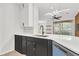 Modern kitchen with white countertops, black cabinets and stainless steel appliances at 6149 Metrowest Blvd # 103, Orlando, FL 32835