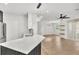 Open kitchen featuring quartz counters, modern lighting, and views of the living space at 6149 Metrowest Blvd # 103, Orlando, FL 32835