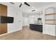 Bright living room featuring sleek floors, modern decor, and an open layout flowing into the kitchen at 6149 Metrowest Blvd # 103, Orlando, FL 32835