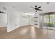 Spacious living room with a dining area, light floors, bright windows, and sliding glass doors at 6149 Metrowest Blvd # 103, Orlando, FL 32835