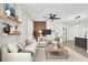 Cozy living room featuring modern decor, wood accent wall, and ceiling fan at 6149 Metrowest Blvd # 103, Orlando, FL 32835