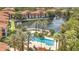 View of community with pool, water feature, and palm trees providing shade for residents at 6149 Metrowest Blvd # 103, Orlando, FL 32835