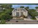 Aerial view of the building featuring a waterfront location, surrounded by lush landscaping at 690 Osceola Ave # 410, Winter Park, FL 32789