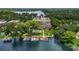 Aerial view showcasing waterfront property with boat docks, a pool, and lush landscaping at 690 Osceola Ave # 410, Winter Park, FL 32789