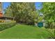 Green backyard with manicured lawn and lush trees at 690 Osceola Ave # 410, Winter Park, FL 32789