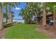 Lush green backyard featuring a kayak rack, seating area, and access to the waterfront at 690 Osceola Ave # 410, Winter Park, FL 32789