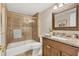 Well-lit bathroom featuring a glass shower, granite vanity, and framed mirror at 690 Osceola Ave # 410, Winter Park, FL 32789