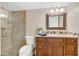 Bathroom featuring a glass shower, granite vanity, and framed mirror at 690 Osceola Ave # 410, Winter Park, FL 32789