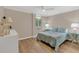 Cozy bedroom with a ceiling fan, wood floors, and a bright window at 690 Osceola Ave # 410, Winter Park, FL 32789
