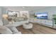 Open living area with TV and views into the modern, white kitchen at 690 Osceola Ave # 410, Winter Park, FL 32789