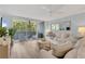 Bright living room with large sliding glass doors to balcony and coastal decor at 690 Osceola Ave # 410, Winter Park, FL 32789