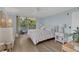 Bedroom with large windows providing outdoor views and sliding glass door to balcony at 690 Osceola Ave # 410, Winter Park, FL 32789