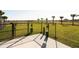 Community dog park with fenced-in area, grassy space, and convenient waste disposal stations at 7538 Headwaters Ct, Groveland, FL 34736
