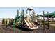 Community playground with slides, climbing structures, and safety surfacing for outdoor fun at 7538 Headwaters Ct, Groveland, FL 34736