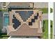 Aerial view of a house featuring a new solar panel installation and private screened-in pool at 7613 Wandering Way, Orlando, FL 32836