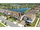 Overhead view showcases a luxury community of homes surrounding a large lake with a beautiful water feature at 7613 Wandering Way, Orlando, FL 32836