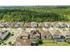 Aerial view of a new residential community with neatly lined houses and well-maintained lawns and landscaping at 7613 Wandering Way, Orlando, FL 32836