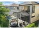 An aerial view highlights the outdoor screened-in pool, patio and dining areas at 7613 Wandering Way, Orlando, FL 32836