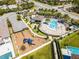 Overhead view of community featuring a pool, playground, lounge area, green spaces, and parking at 7613 Wandering Way, Orlando, FL 32836