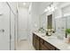 Modern bathroom featuring dual sinks, stylish fixtures, a glass-enclosed shower and tiled floors at 7613 Wandering Way, Orlando, FL 32836