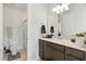 Well-lit bathroom featuring a vanity, a shower, and classic neutral tones at 7613 Wandering Way, Orlando, FL 32836