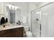Bright bathroom featuring a walk-in shower, vanity with a sink, and modern fixtures at 7613 Wandering Way, Orlando, FL 32836