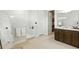 Bright bathroom features a walk-in shower, vanity with double sinks, and a walk-in closet at 7613 Wandering Way, Orlando, FL 32836