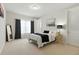 Bright bedroom features a dark-toned mirror, a door, and soft, neutral decor at 7613 Wandering Way, Orlando, FL 32836