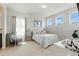 Inviting bedroom features neutral tones, natural light, and a cozy chair for relaxation at 7613 Wandering Way, Orlando, FL 32836