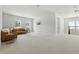 Expansive bonus room with comfortable seating area, lots of natural light, perfect for relaxing or entertaining at 7613 Wandering Way, Orlando, FL 32836