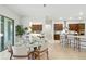 Elegant dining area adjacent to the kitchen with a stylish table and view of the gourmet kitchen at 7613 Wandering Way, Orlando, FL 32836