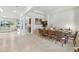 Bright, open dining room featuring a large table with seating for eight at 7613 Wandering Way, Orlando, FL 32836