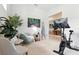 Comfortable exercise room featuring a Peloton bike and cozy seating area at 7613 Wandering Way, Orlando, FL 32836