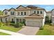 Beautiful two-story home featuring a well-manicured lawn, and a two-car garage at 7613 Wandering Way, Orlando, FL 32836