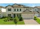 Charming two-story home with a well-manicured lawn, lush landscaping, and a two-car garage at 7613 Wandering Way, Orlando, FL 32836