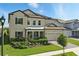 Charming two-story home boasts a well-manicured lawn, lush landscaping, and a two-car garage at 7613 Wandering Way, Orlando, FL 32836
