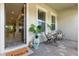 Inviting front porch with cozy seating, plants, and a welcome mat at 7613 Wandering Way, Orlando, FL 32836