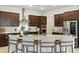 Elegant kitchen with a large island, stainless steel appliances, and stylish bar stools at 7613 Wandering Way, Orlando, FL 32836