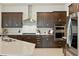Chef's kitchen showcasing dark wood cabinetry, stainless appliances, and sleek countertops at 7613 Wandering Way, Orlando, FL 32836