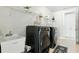 Well-equipped laundry room with modern washer and dryer, sink, and ample storage space for laundry essentials at 7613 Wandering Way, Orlando, FL 32836
